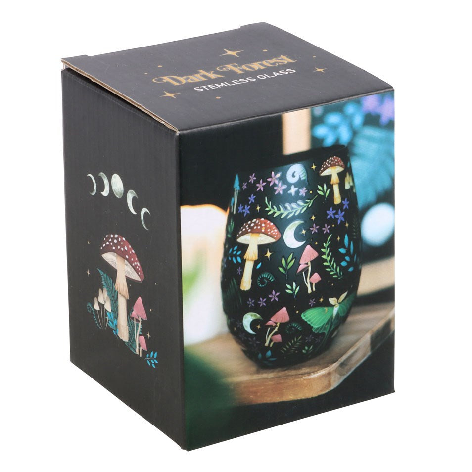 Stemless wineglass with all over patterns on black of mushrooms, ferns, luna moth, moon and stars, flowers. Shown in box with text "Dark Forest Stemless Glass"