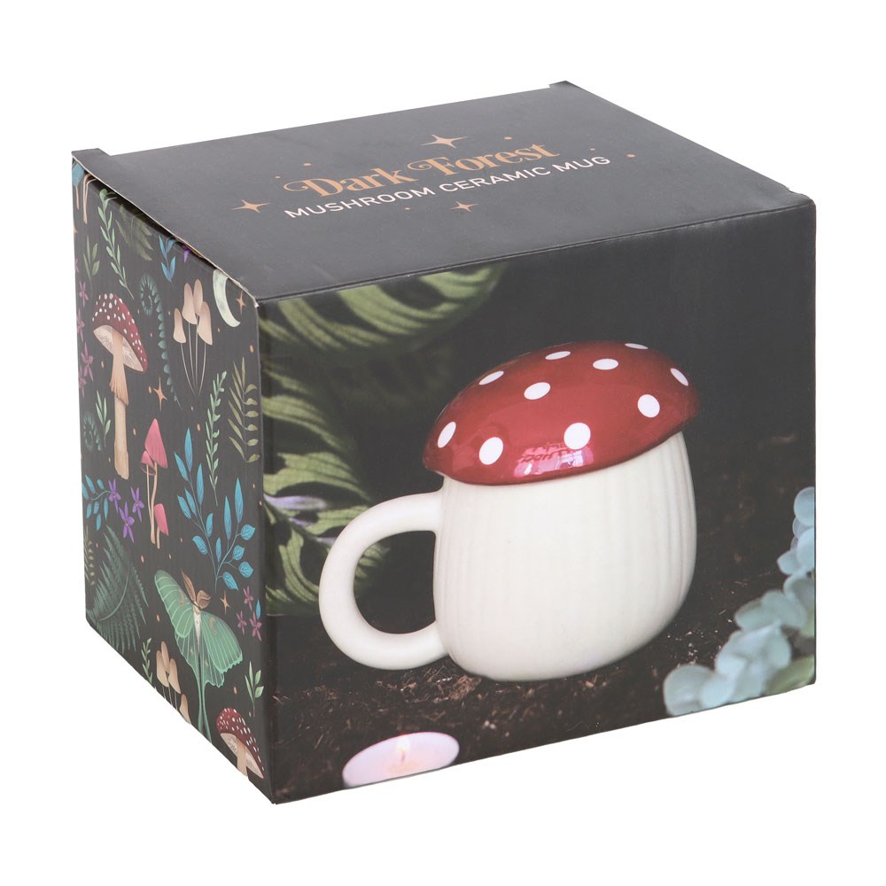 Mushroom shaped lidded mug in white and red, shown in box with text "Dark Forest - Mushroom Ceramic Mug"