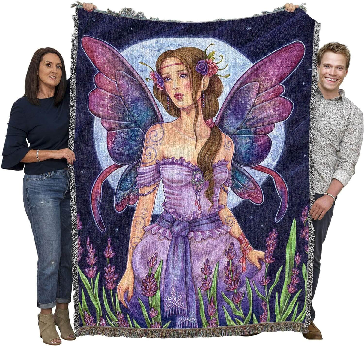 Tapestry blanket with art by Brigid Ashwood. Fairy in purple dress with purple-blue wings standing in a flower field with full moon beyond. Shown held by two adults