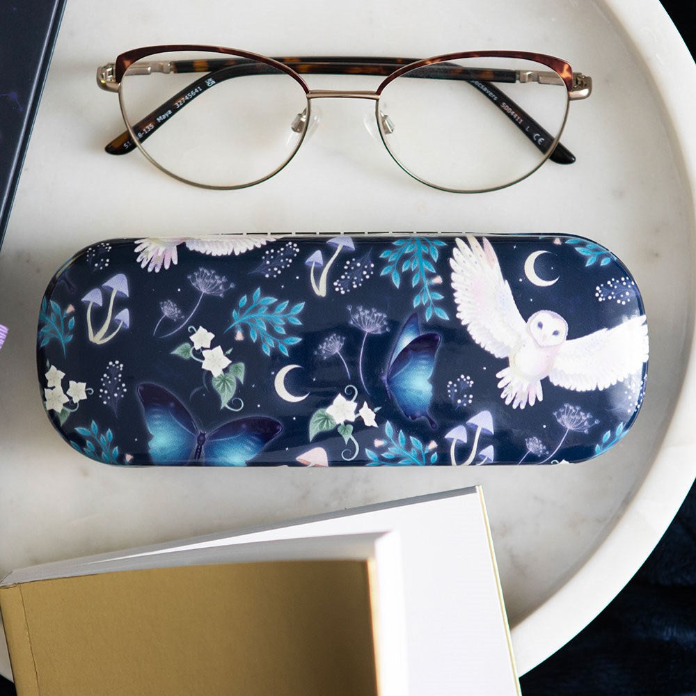 Glasses case, blue with flowers, mushrooms, owl, moths, moon, shown with glasses