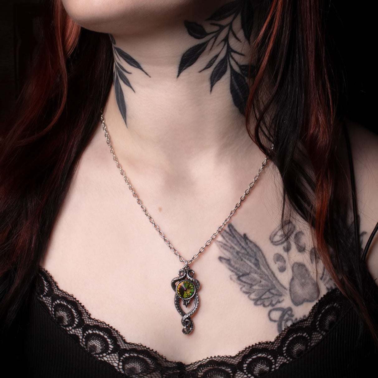 Pendant necklace with rainbow Austrian crystal and pewter tentacles wrapped around, shown worn
