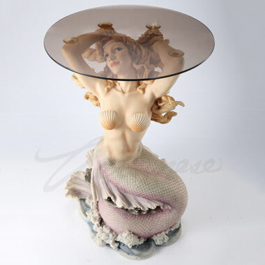 Glass topped mermaid table. Mermaid has blond hair and a pink tail, sitting on waves