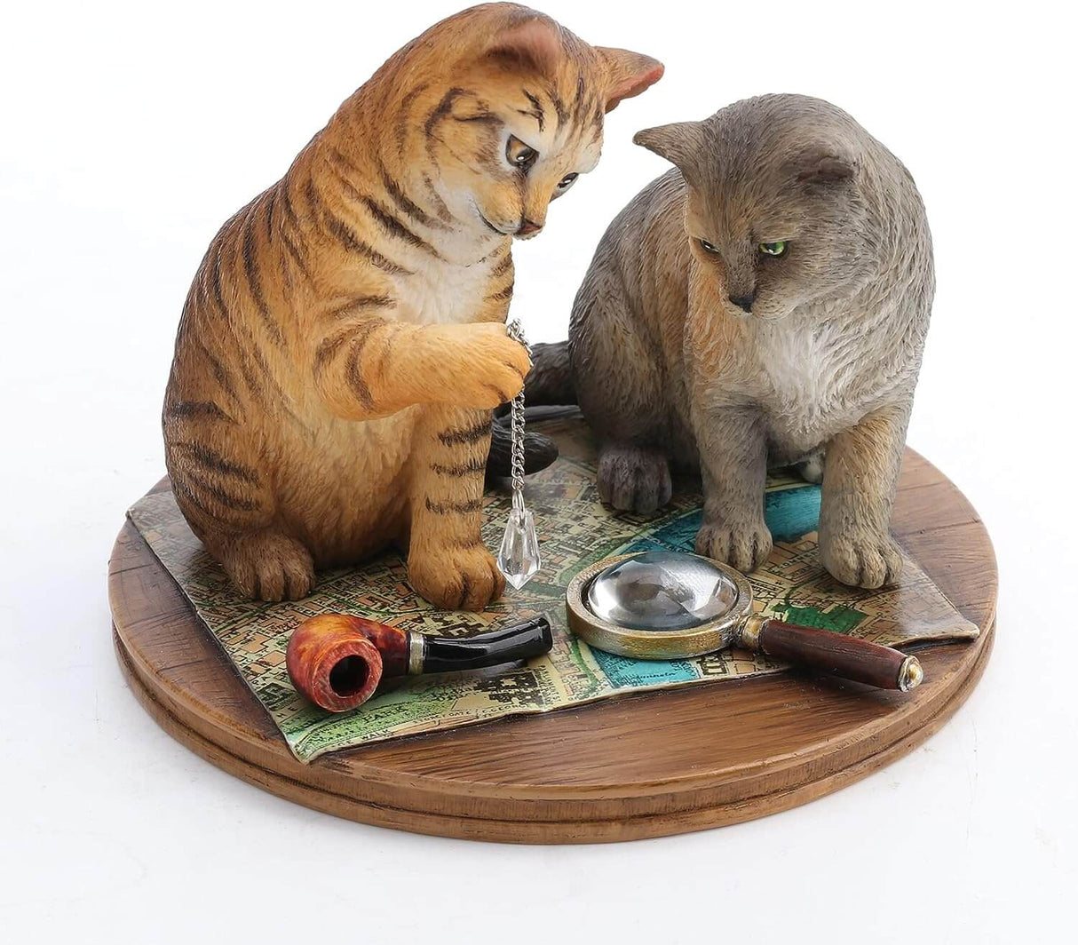 Orange tabby and grey cat contemplate a crystal while sitting on a map with magnifying glass & pipe nearby. Figurine based on artwork of Lisa Parker