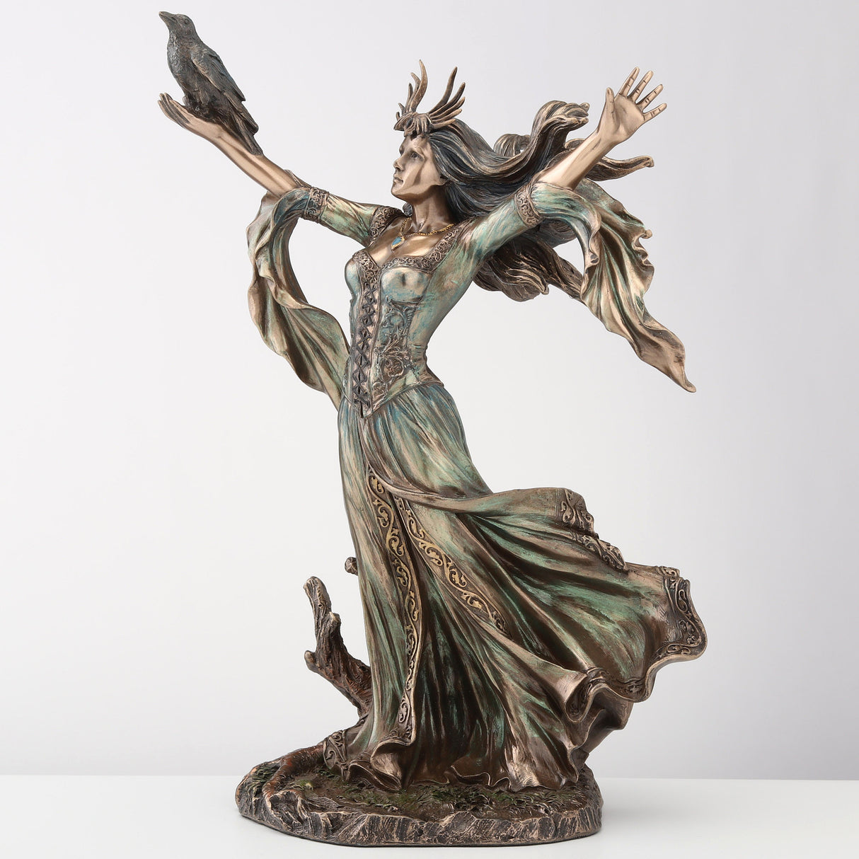 Figurine of the sorceress Morgan le Fey from Arthurian legend. Bronze hue with raven on arm, flowing dress and hair