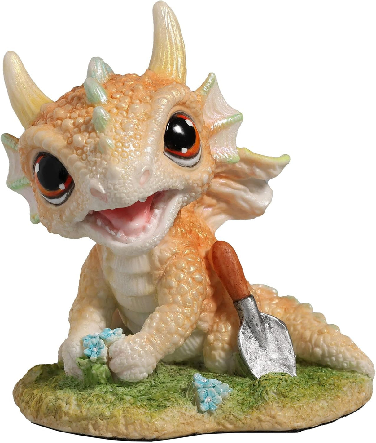 Figurine of a pale gold baby dragon gardening with flowers and a trowel