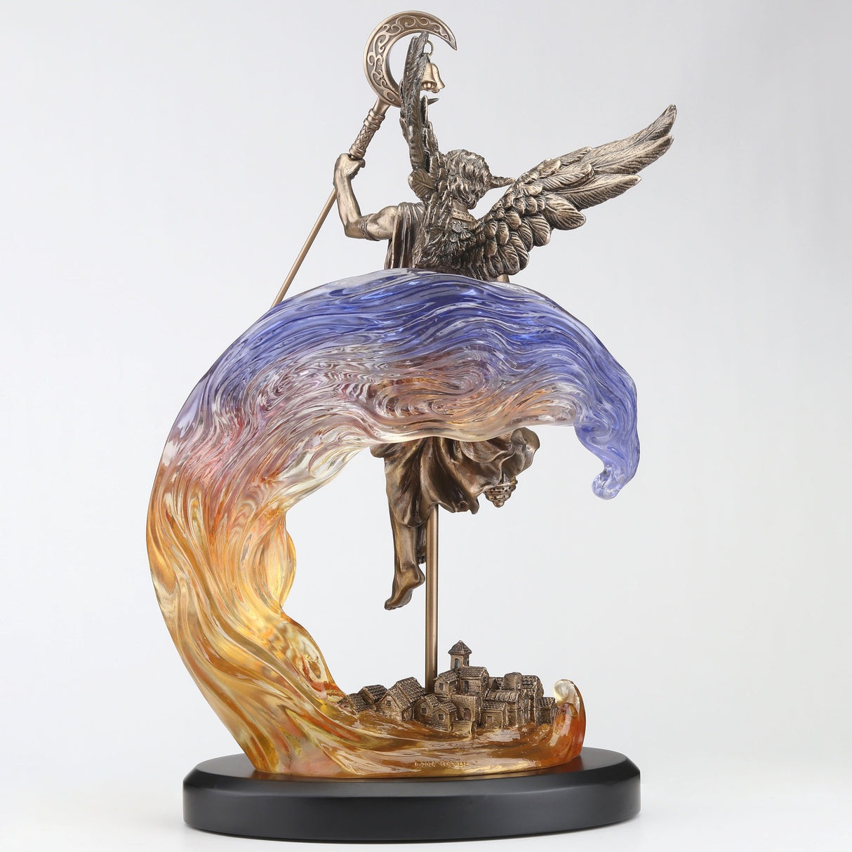 Figurine in bronze hue of Hypnos, Greek god of slumber with lantern and crescent moon staff, feathered wings. Behind him in transparent resin is a purple-yellow-orange cloud and a village below in cold cast bronze