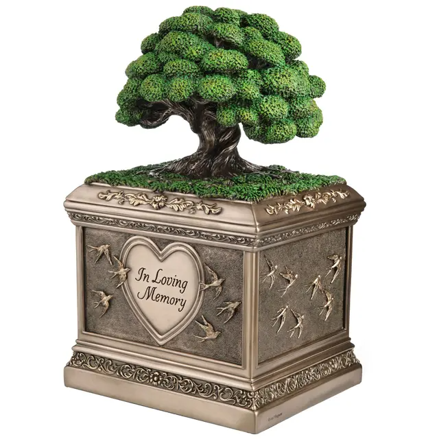 Bronze-hued urn with Tree of Life on top. Heart and swallows along the sides