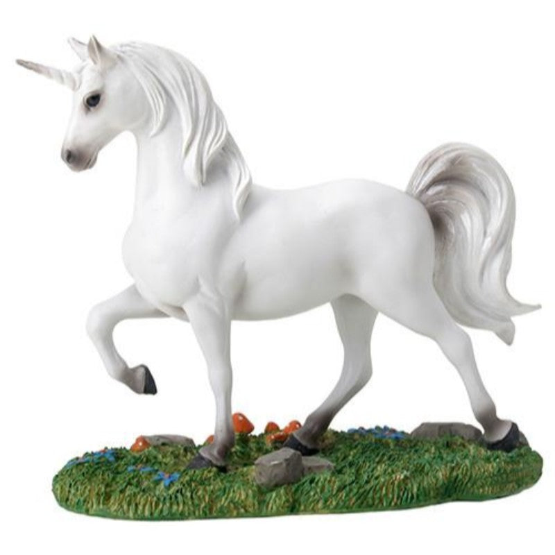 Figurine of a white prancing unicorn i the grass with small mushrooms