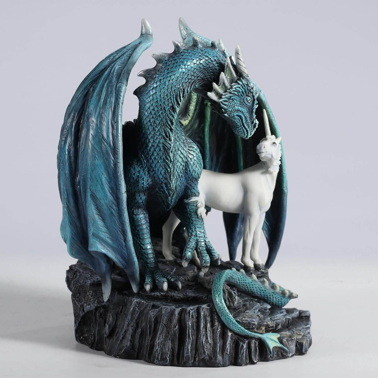 Green-blue dragon and unicorn stand together on a rock
