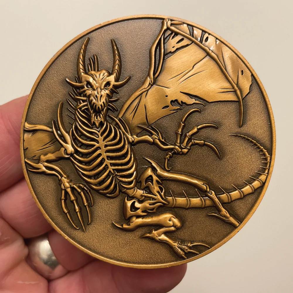 Collectible coin, antique copper color, skeletal dragon