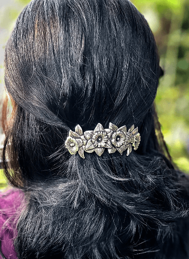 Daffodil barrette shown in dark hair