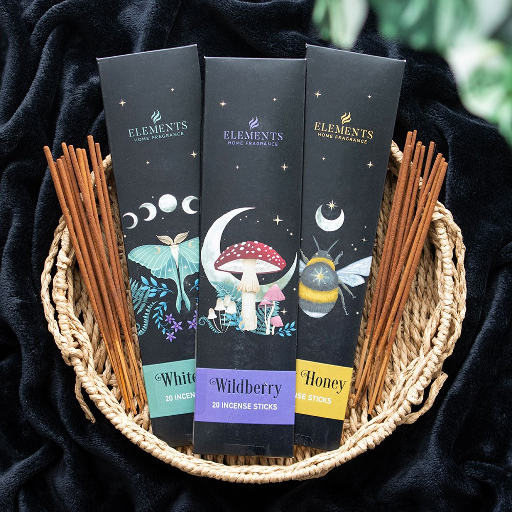 Three packages of incense with dark forest imagery. Wildberry, Sweet Honey, and White Sage