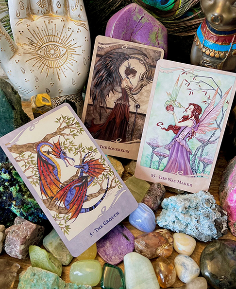 Card examples arranged on gemstones. The Ground dragon card, The Sovereign fairy, The Way Maker Fairy