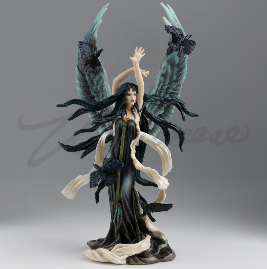 Figurine of fairy with black hair and dress and feathered angel wings, surrounded by ravens