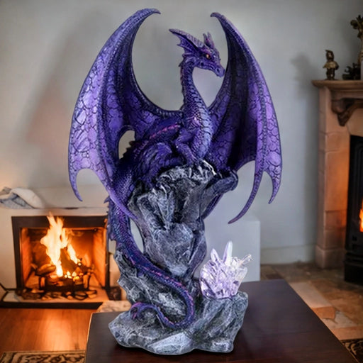 purple dragon on desk in front of fireplace