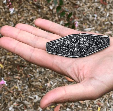 Flowers barrette in palm of a hand showing size