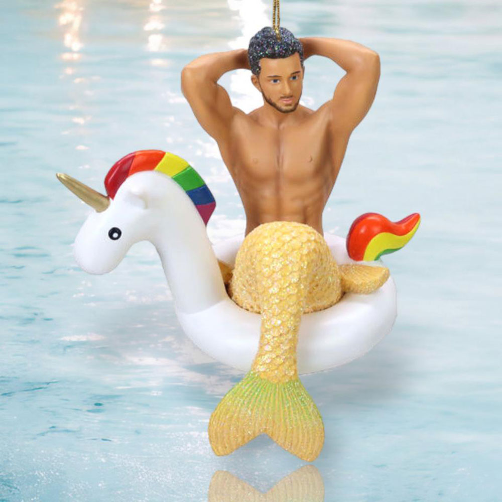 Decorative ornament of a merman with a glittery yellow tail sitting in an inflatable unicorn float.