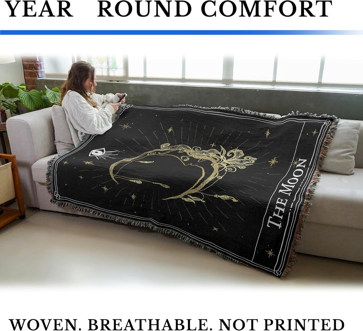 Person sitting on a couch with a decorative blanket featuring 'The Moon' design. Text around it reads, "Year Round Comfort" and "Woven. Breathable. Not Printed"