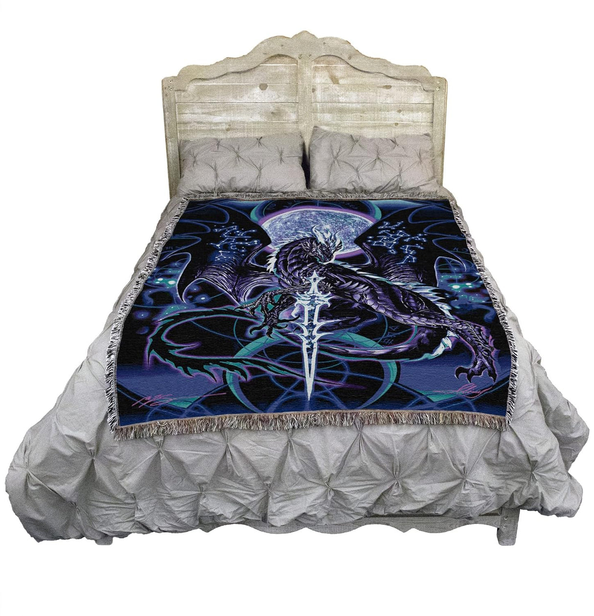 Tapestry blanket, art by Ruth Thompson, purple black dragon in front of full moon, constellations on its wings and a glowing sword front and center. Shown draped over a bed