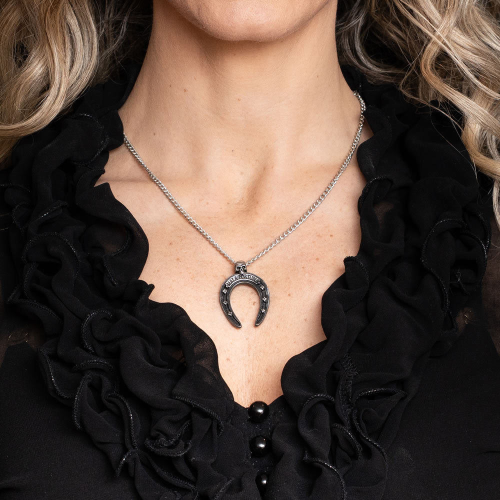 Horseshoe-shaped pendant with 'Mala Fortuna' text and a small skull at the top, shown worn