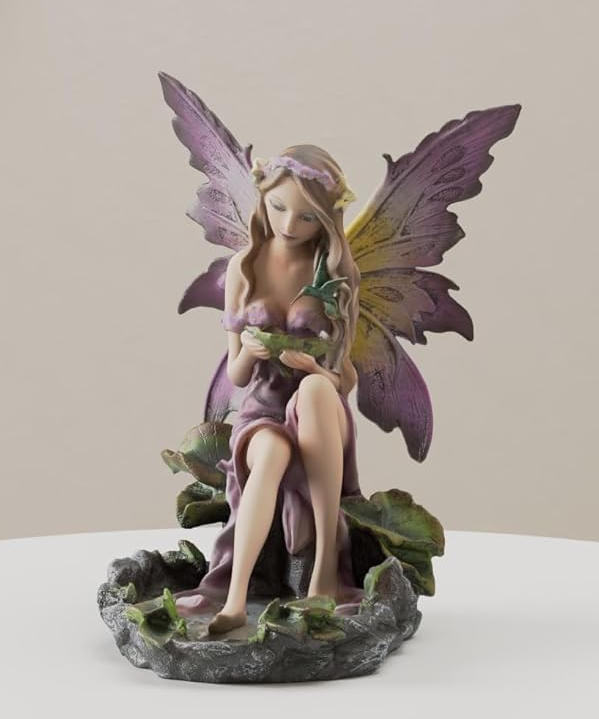 Fairy figurine, pink wings and dress, sitting with feet in pond and leaves in hand