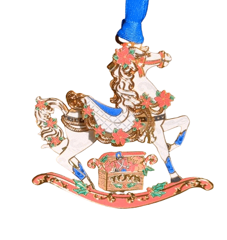 Brass rocking horse ornament with a box of toys, accented in holly and poinsettia