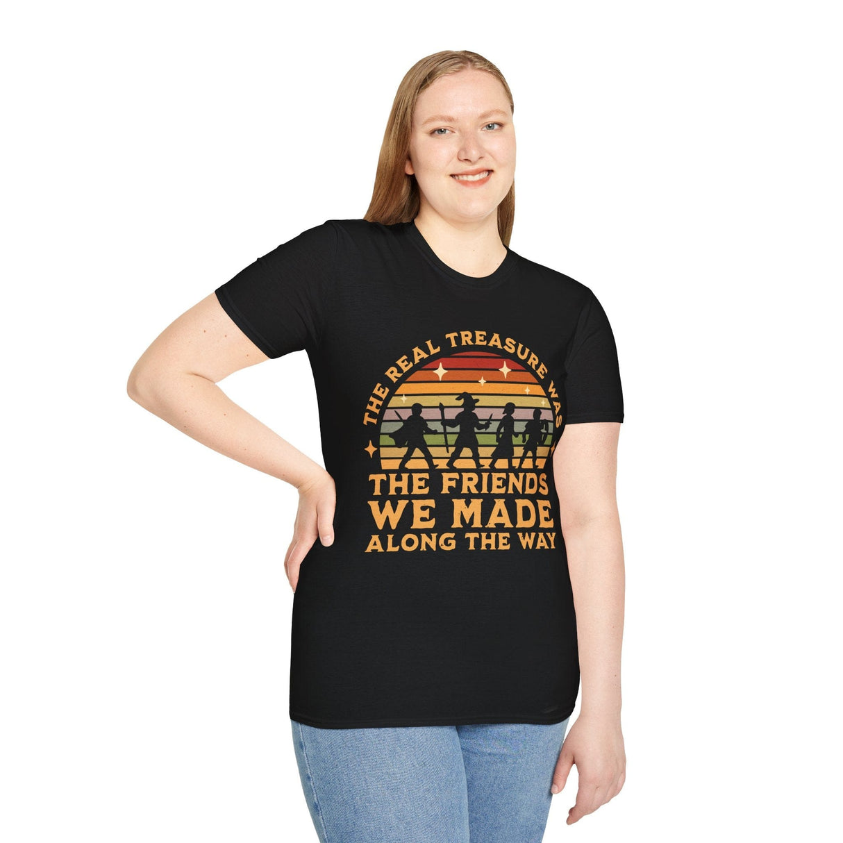 Woman wearing black t-shirt with vintage-style rainbow & adventurers graphic and text reading "The real treasure was the friends we made along the way"