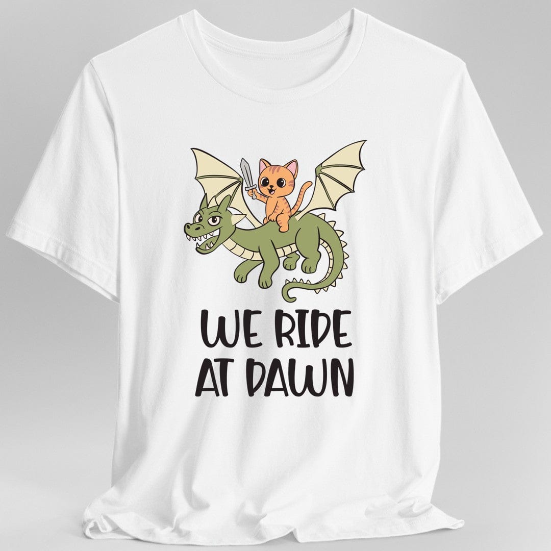 White t-shirt with a cat riding a dragon graphic and 'We Ride at Dawn' text