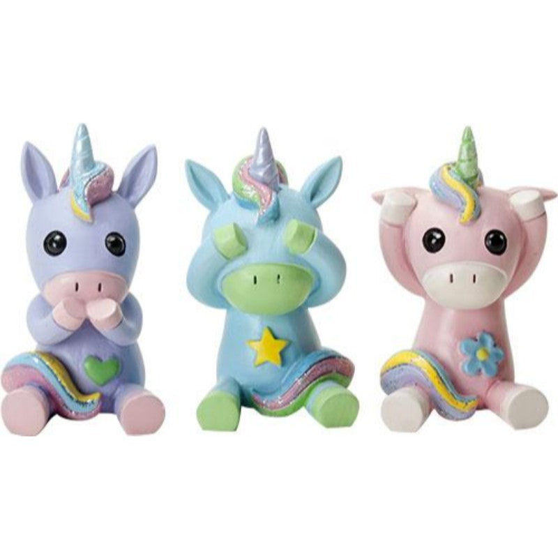 Set of 3 figurines, pastel unicorns. First is "Speak No Evil" - purple with rainbow hair, green heart pink accents. Second is blue "See No Evil" with green accents, rainbow hair, yellow star. Third is "Hear No Evil", pink with white accents, rainbow hair, blue flower