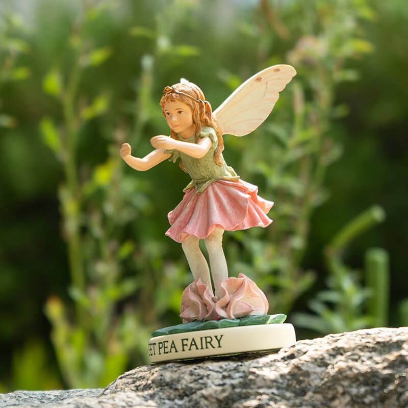 Flower fairy figurine of girl pixie with green and pink flower dress, base reads "Sweet Pea Fairy"