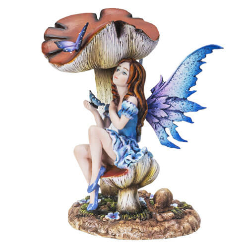 The statue shows a fairy sitting on a toadstool. She wears a dress of ruffled blue, and has indigo wings to match. A butterfly perches on her hand, and another purple flutterby sits on a taller mushroom.