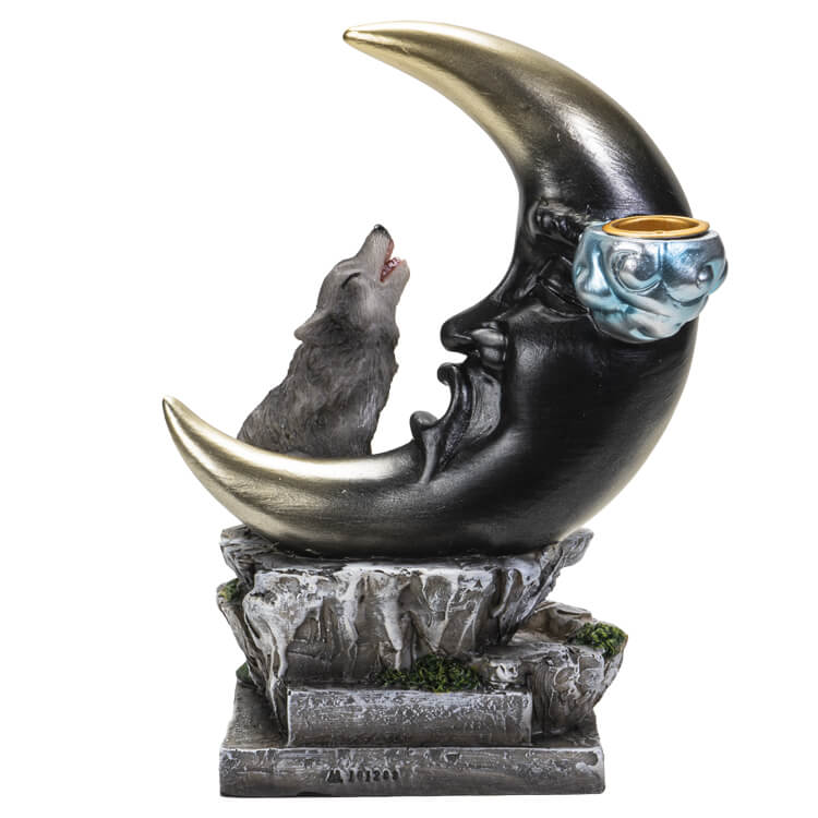 The incense burner features a black and gold-tipped crescent moon with a face. Next to the moon, a gray wolf howls to the heavens.