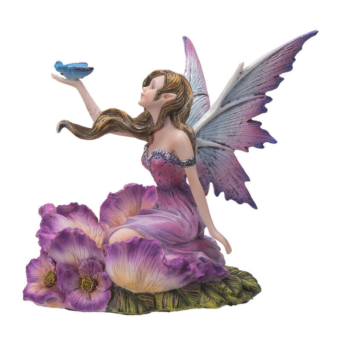 Fairy figurine; she has brown hair and a purple dress surrounded by matching flowers. She looks up at the blue butterfly perched on her outstretched hand. Shown from the side.