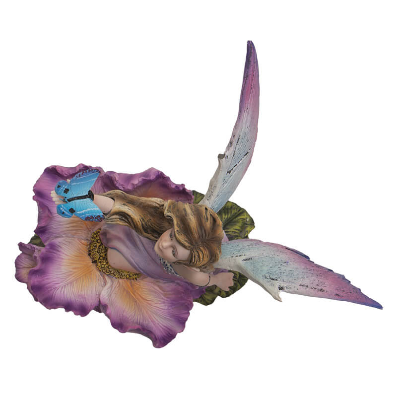 Fairy figurine; she has brown hair and a purple dress surrounded by matching flowers. She looks up at the blue butterfly perched on her outstretched hand. Shown top down, from above