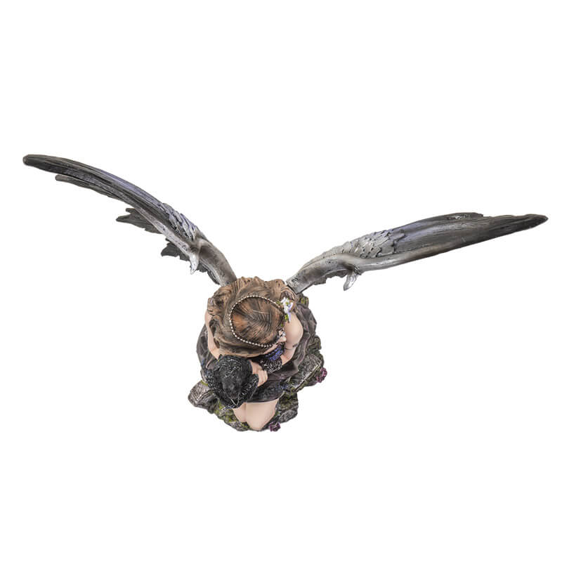 Top down view from above of the fairy and crow figurine