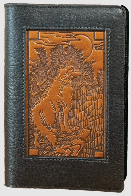 Leather cover with black surrounding a brown scene with a wolf climbing a mountain