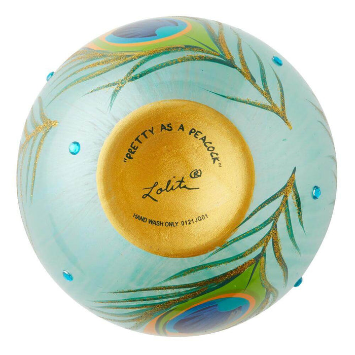 Bottom of stemless peacock wineglass showing gold base with text "Pretty As A Peacock", "Lolita" and "Hand Wash Only"