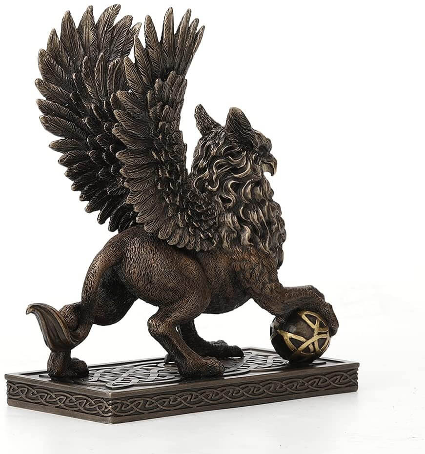 Griffin standing on a Celtic knot base, claw on a sphere with more knotwork. Back view
