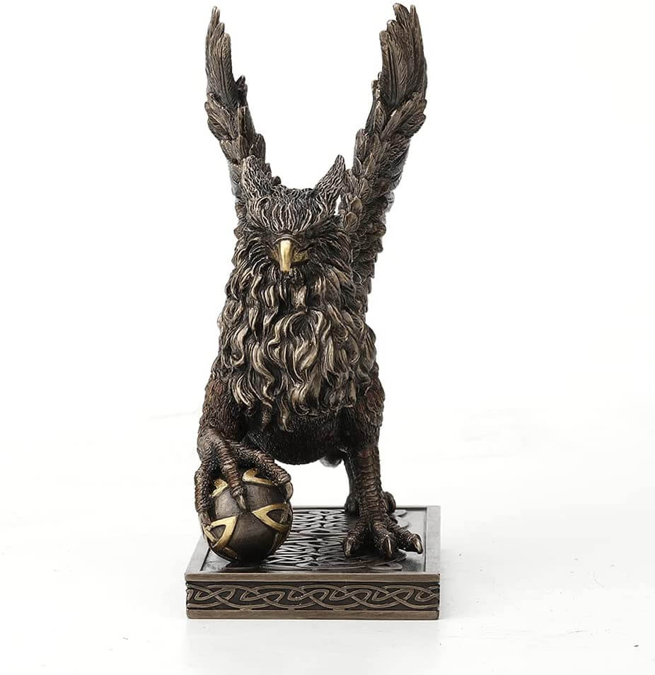 Griffin standing on a Celtic knot base, claw on a sphere with more knotwork. Front view
