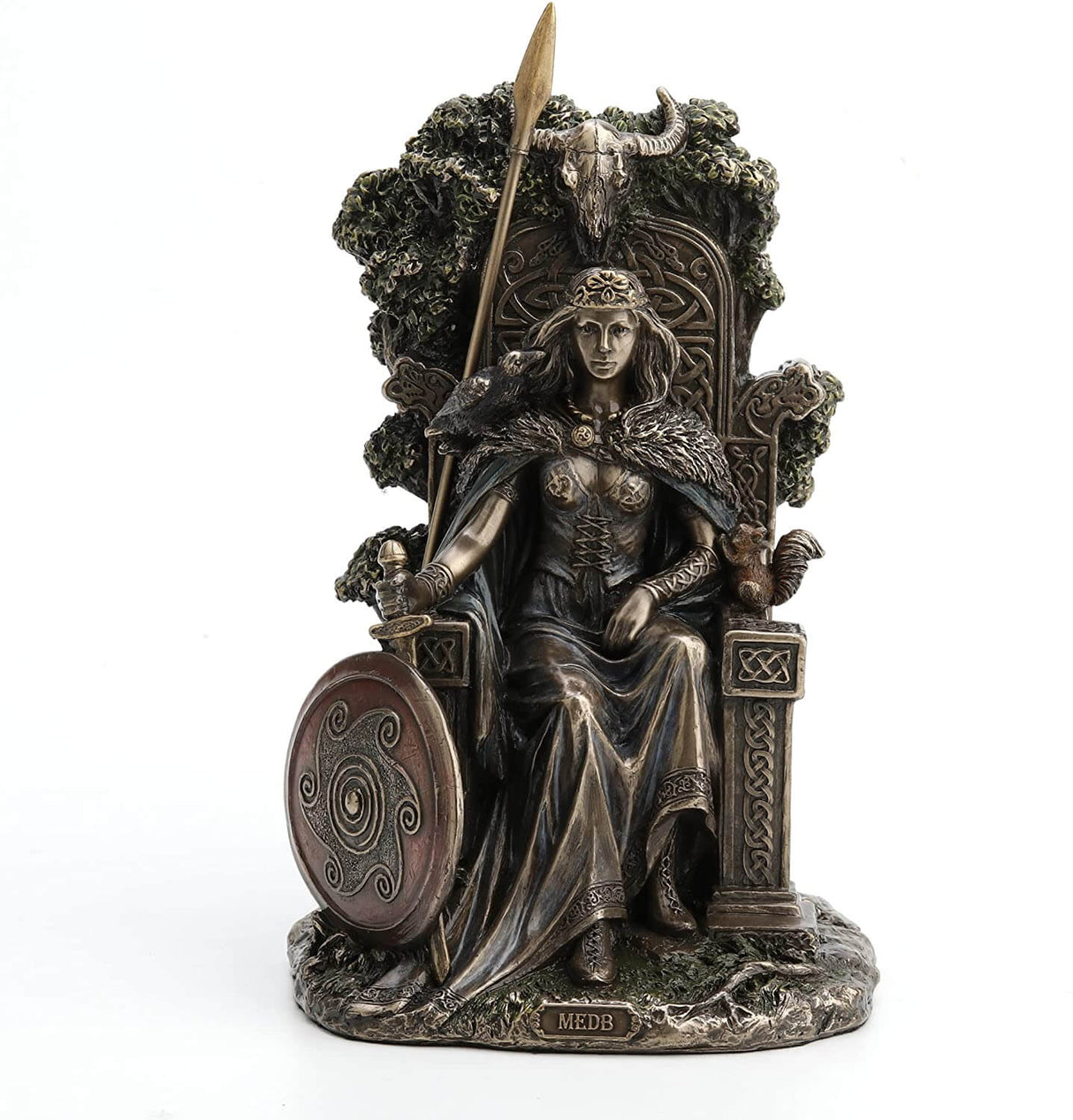 Queen Medb is represented sitting upon a throne decorated with knotwork. Her shield and spear are at the ready, her sword in her hand. A tree grows from behind her seat.