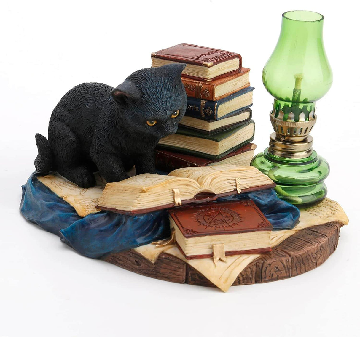 Black cat reading a book next to more tomes and a green lamp