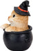 Orange tabby kitten in a witch hat, sitting in a black cauldron. Side view