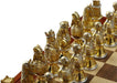Closeup of gold chess pieces with silver accents
