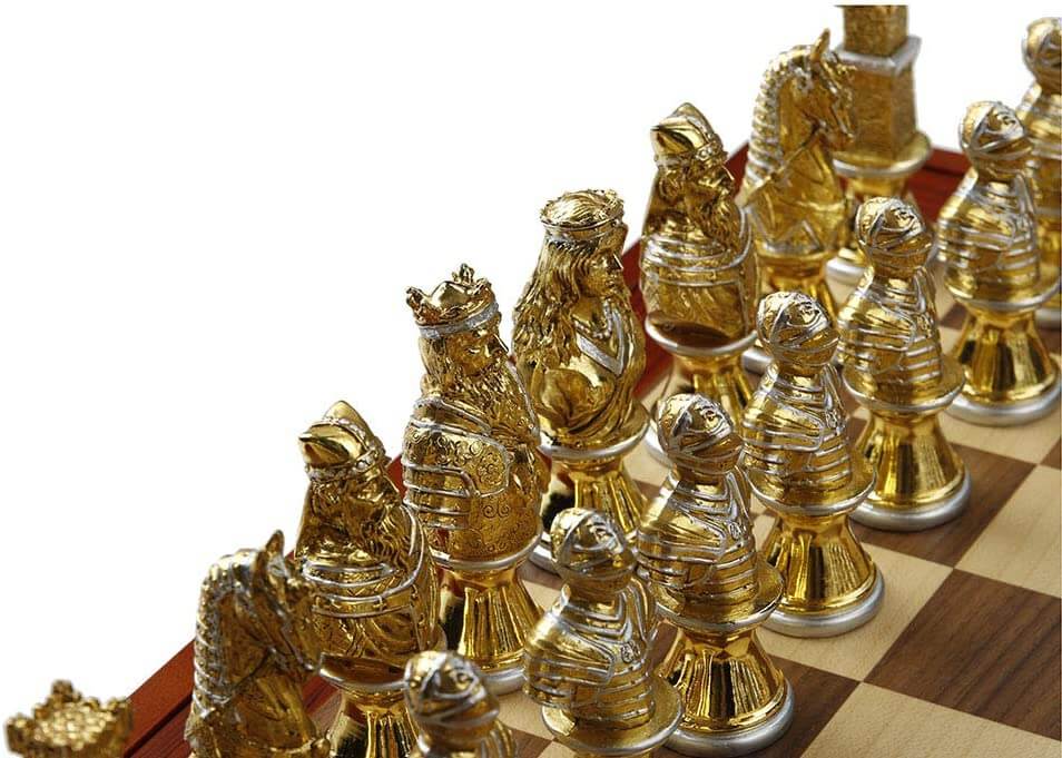 Closeup of gold chess pieces with silver accents