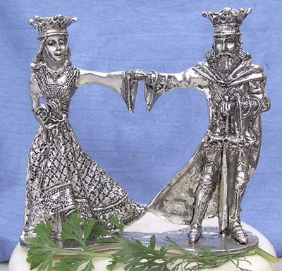 Arthur & Guinevere pewter wedding cake topper with King Arthur and Guinevere Holding hands. King Arthur has sword and Guin is holding a bouquet of flowers.