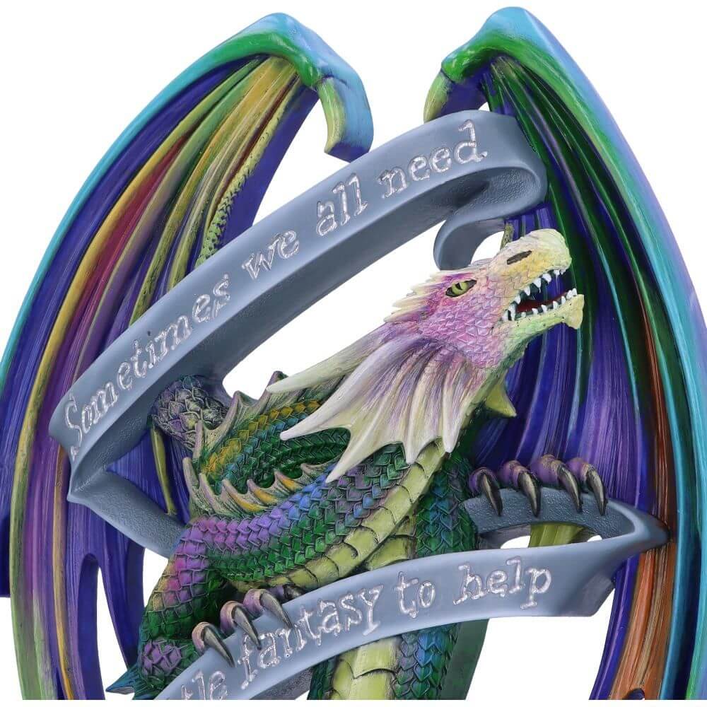 Wall plaque rainbow dragon with words "Sometimes we all need a little fantasy to help survive the reality." Closeup of dragon's colorful face, wings and scales