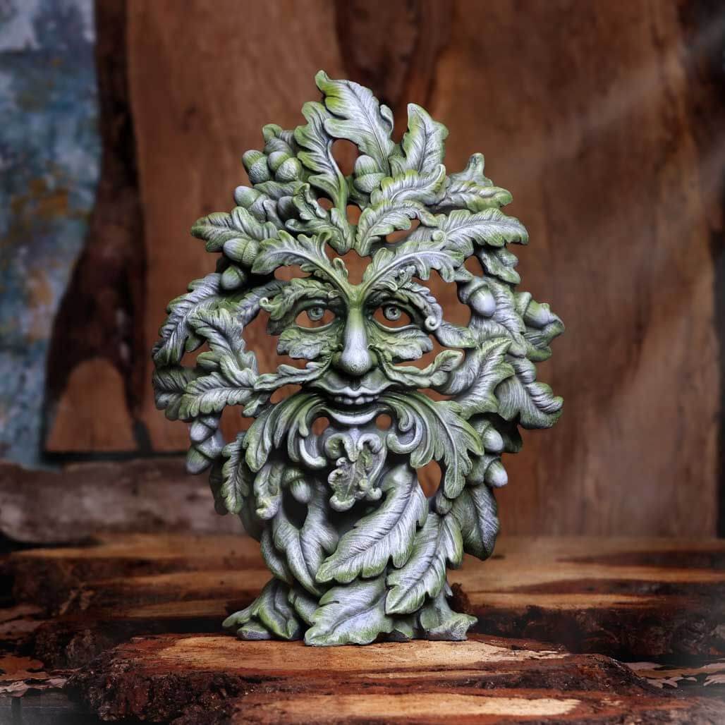 Green man leafy figurine shwon on a wood platform