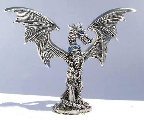 pewter dragon chained with wings spread and feamle holding the dragons chains standing next to the dragon.