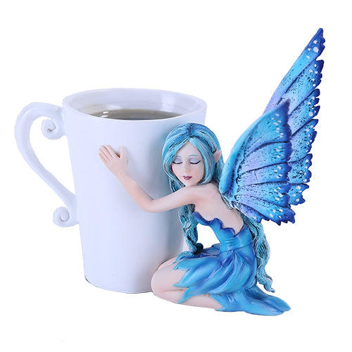 A fairy in blue with matching hair and wings hugs a warm mug of coffee or tea