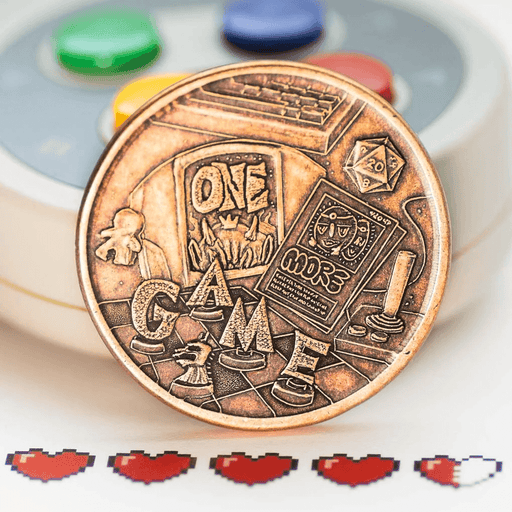Gamer's Decision Maker coin in copper, showing game pieces and the words "One More Game"